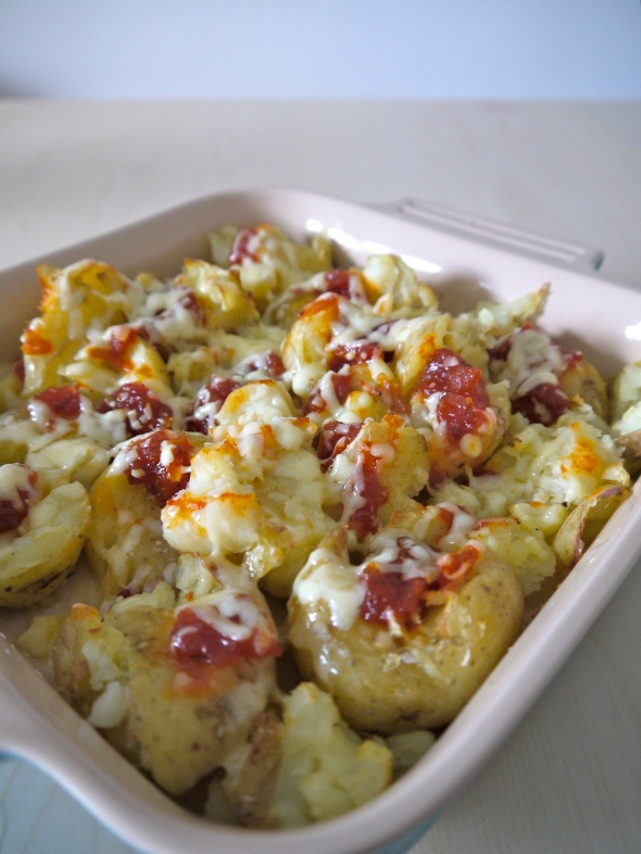 Roasted smashed new potatoes with tomato chutney and cheddar